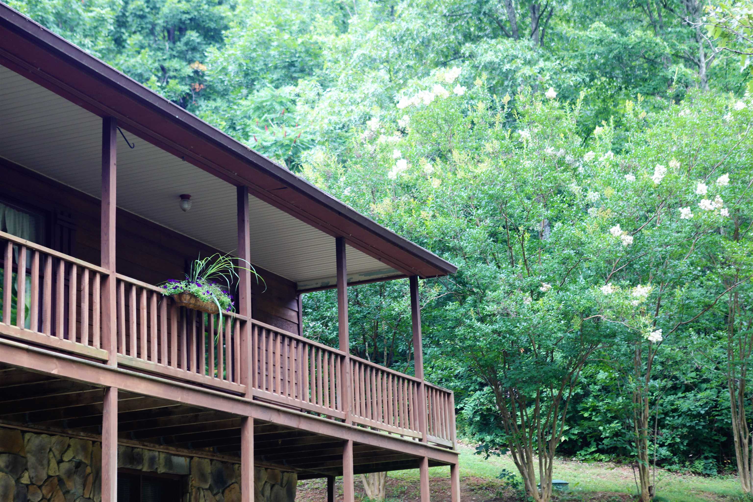 573 Round Hill School Road Fort Defiance, VA 24437 - Photo 2 of 65 a balcony with wooden fence and trees