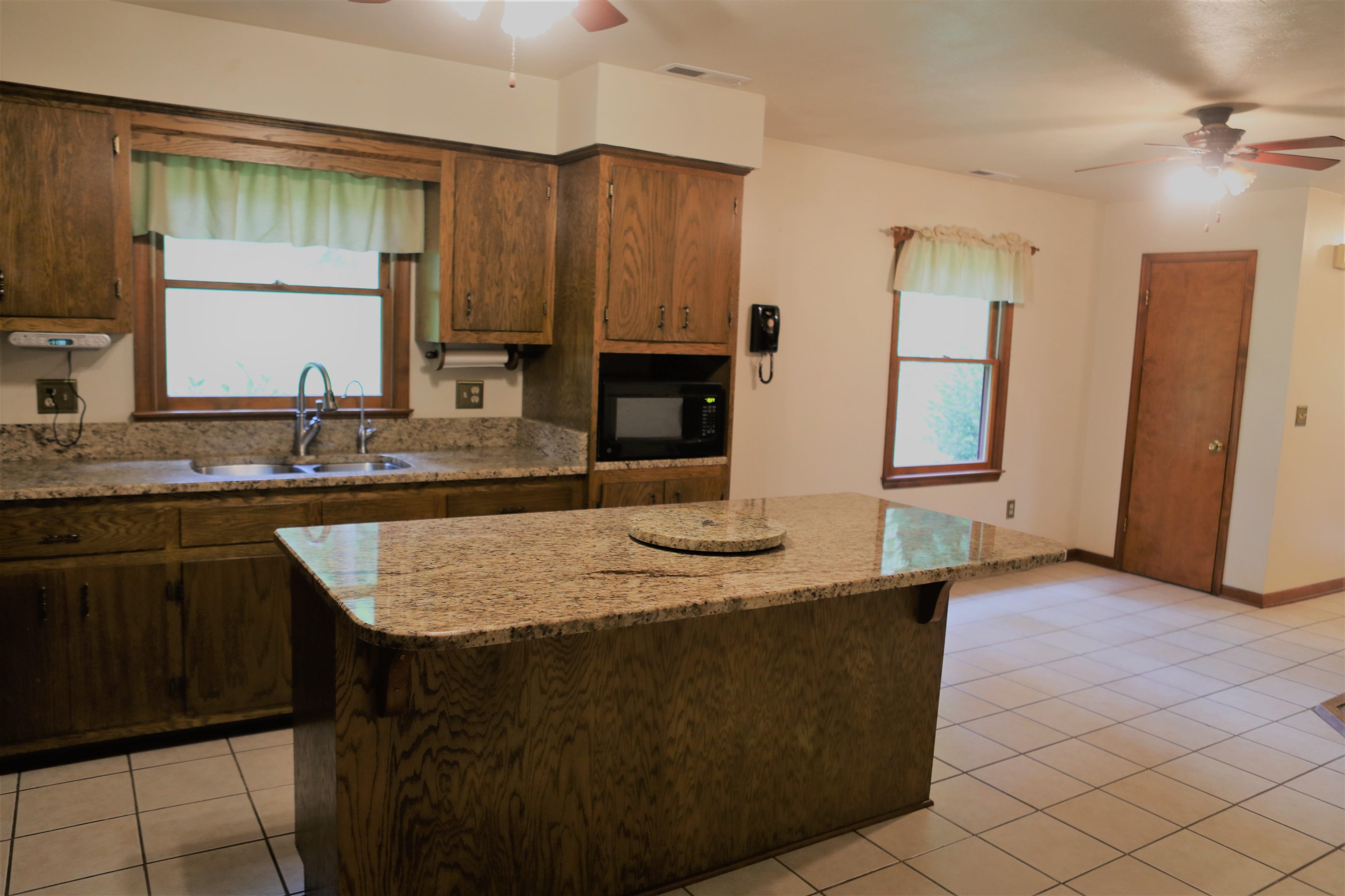 573 Round Hill School Road Fort Defiance, VA 24437 - Photo 29 of 65 a kitchen with a sink and a refrigerator