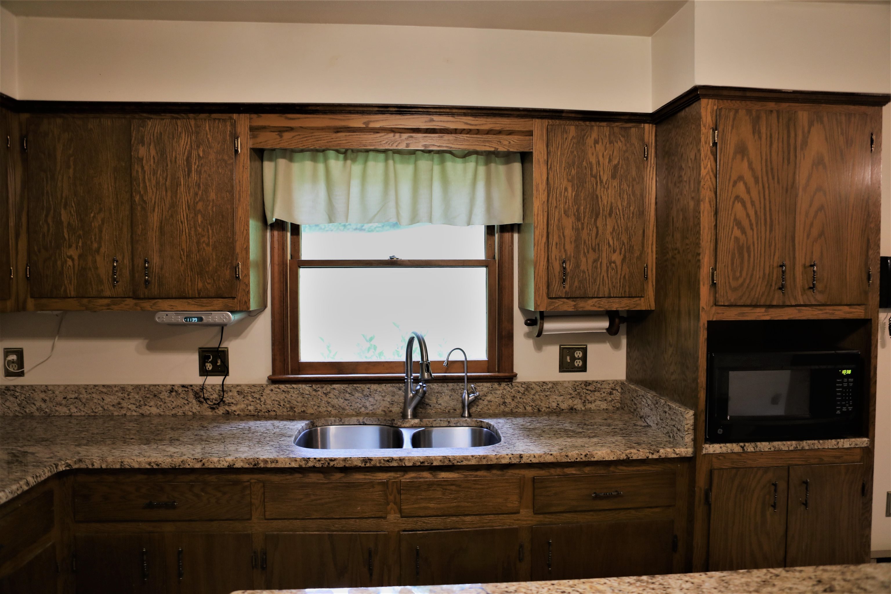 573 Round Hill School Road Fort Defiance, VA 24437 - Photo 31 of 65 a kitchen with granite countertop wooden cabinets and a sink