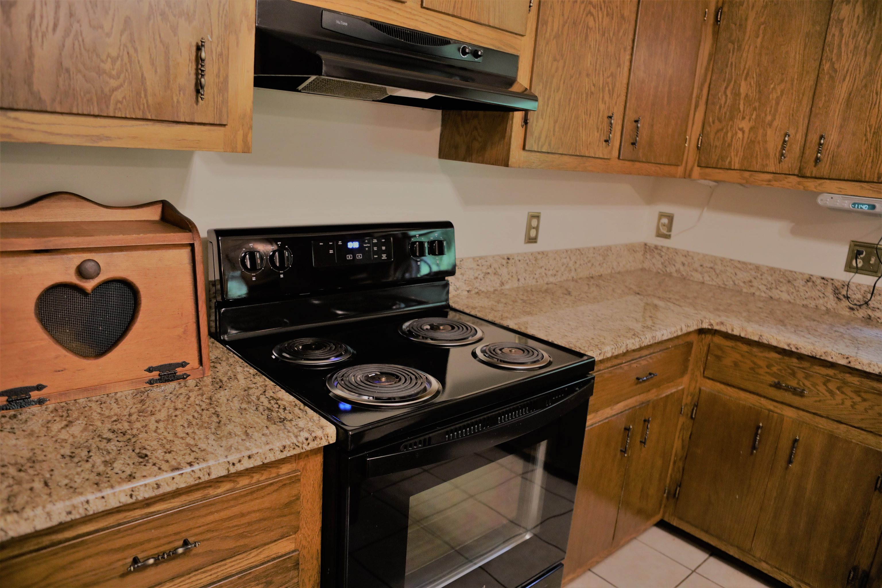 573 Round Hill School Road Fort Defiance, VA 24437 - Photo 39 of 65 a kitchen with a stove and a microwave