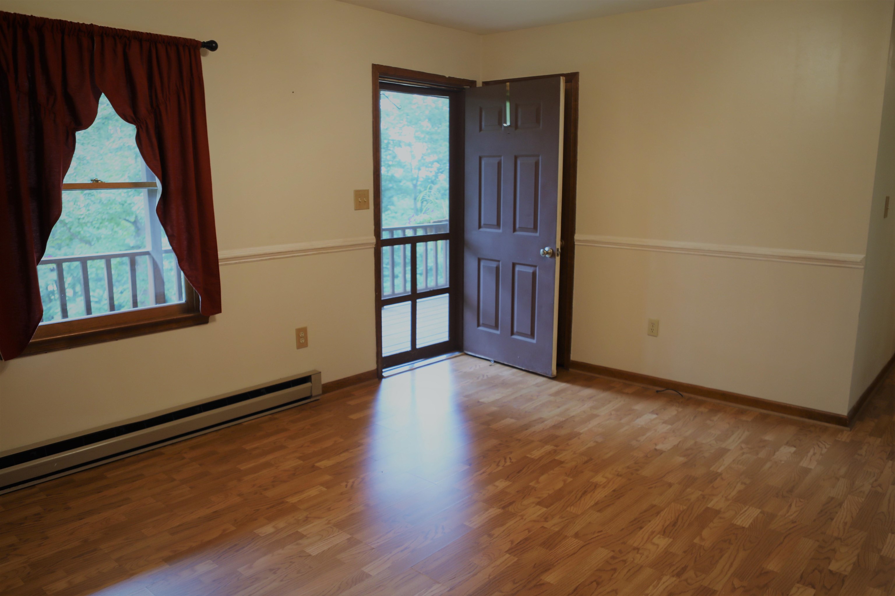 573 Round Hill School Road Fort Defiance, VA 24437 - Photo 41 of 65 an empty room with wooden floor and windows