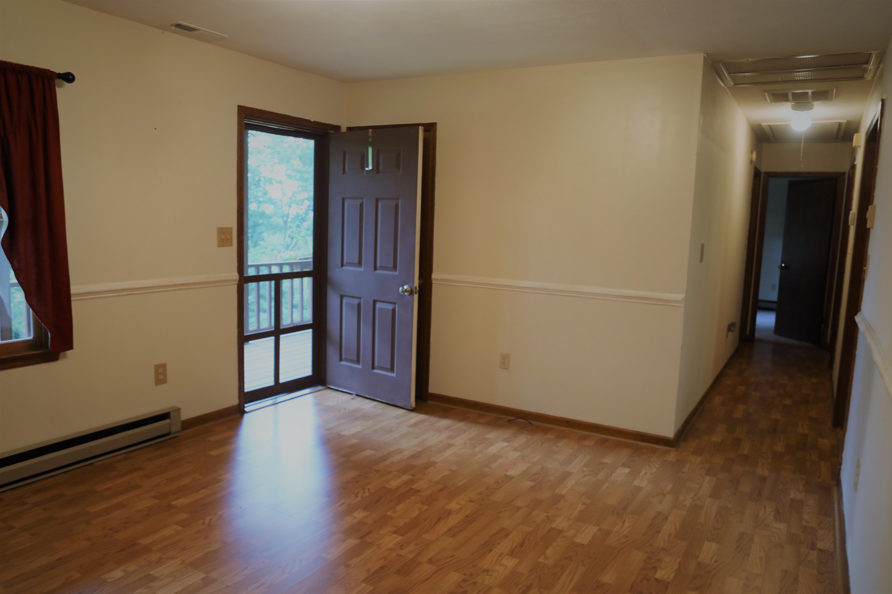 573 Round Hill School Road Fort Defiance, VA 24437 - Photo 42 of 65 a view of an empty room with wooden floor and a window