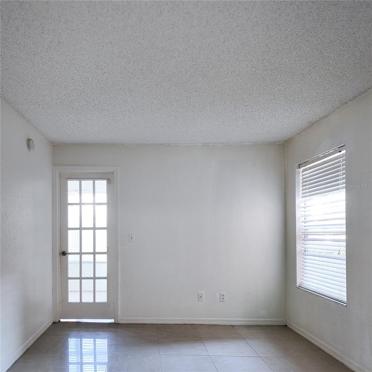5152 Conroy Road, Unit 1317 Orlando, FL 32811 - Photo 11 of 21 an empty room with windows