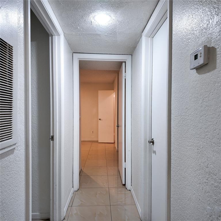 5152 Conroy Road, Unit 1317 Orlando, FL 32811 - Photo 13 of 21 a view of a hallway with closet and a bathroom