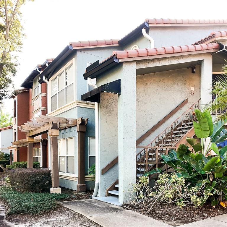 5152 Conroy Road, Unit 1317 Orlando, FL 32811 - Photo 2 of 21 a view of a house with a window and potted plants