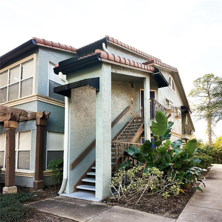 5152 Conroy Road, Unit 1317 Orlando, FL 32811 - Photo 3 of 21 a front view of a house with plants