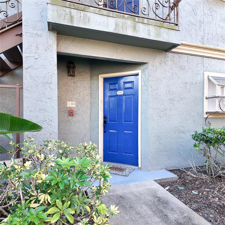5152 Conroy Road, Unit 1317 Orlando, FL 32811 - Photo 4 of 21 a front view of a house with a yard