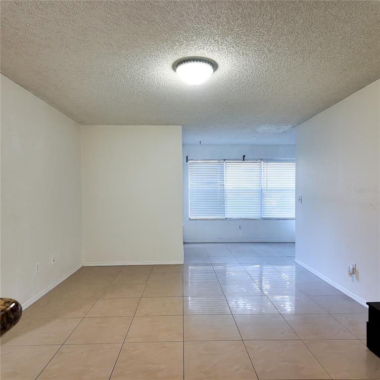 5152 Conroy Road, Unit 1317 Orlando, FL 32811 - Photo 9 of 21 a view of an empty room and window