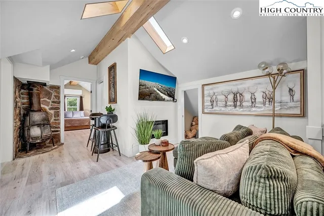 a living room with furniture a fireplace and gym equipment
