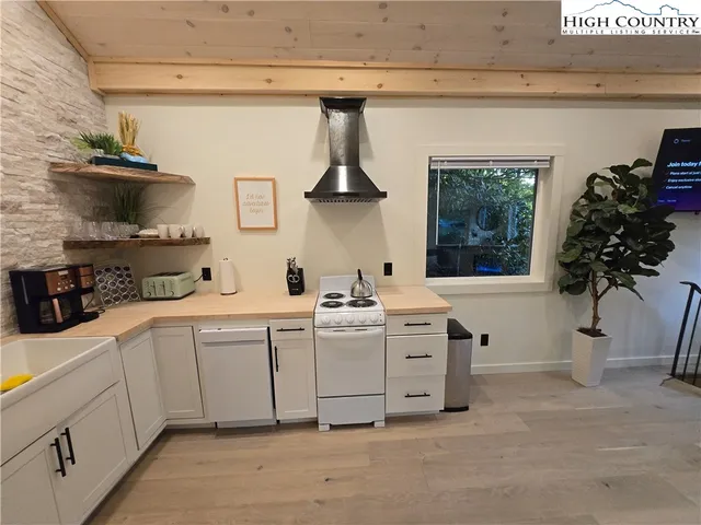a kitchen with stainless steel appliances a sink and cabinets