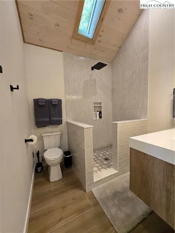 a bathroom with a toilet and a shower