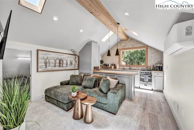 a living room with furniture and kitchen view