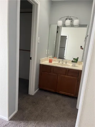 a bathroom with a double vanity sink and mirror