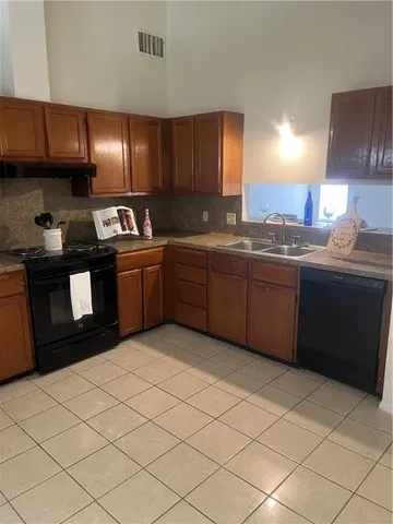 a kitchen with stainless steel appliances granite countertop a sink and a stove