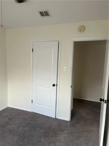 an empty room with closet area