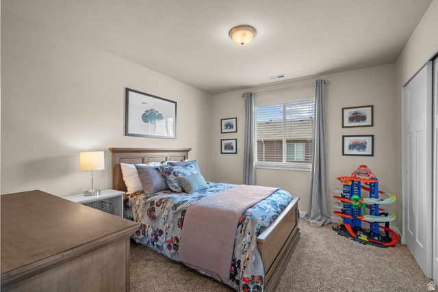 955 Delorean Lane Midvale, UT 84047 - Photo 28 of 47 Neutral wall paint complemented by plush carpet flooring