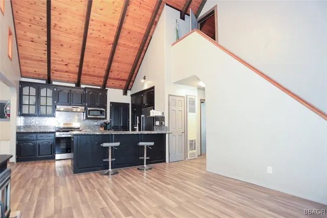 a large bed sitting in a bedroom next to a window