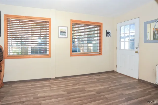 a view of a house with a yard and wooden fence