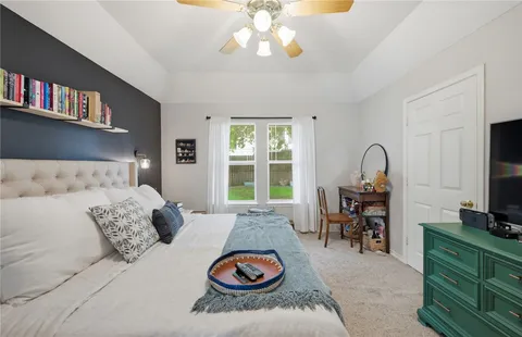 a bedroom with furniture and a book shelf