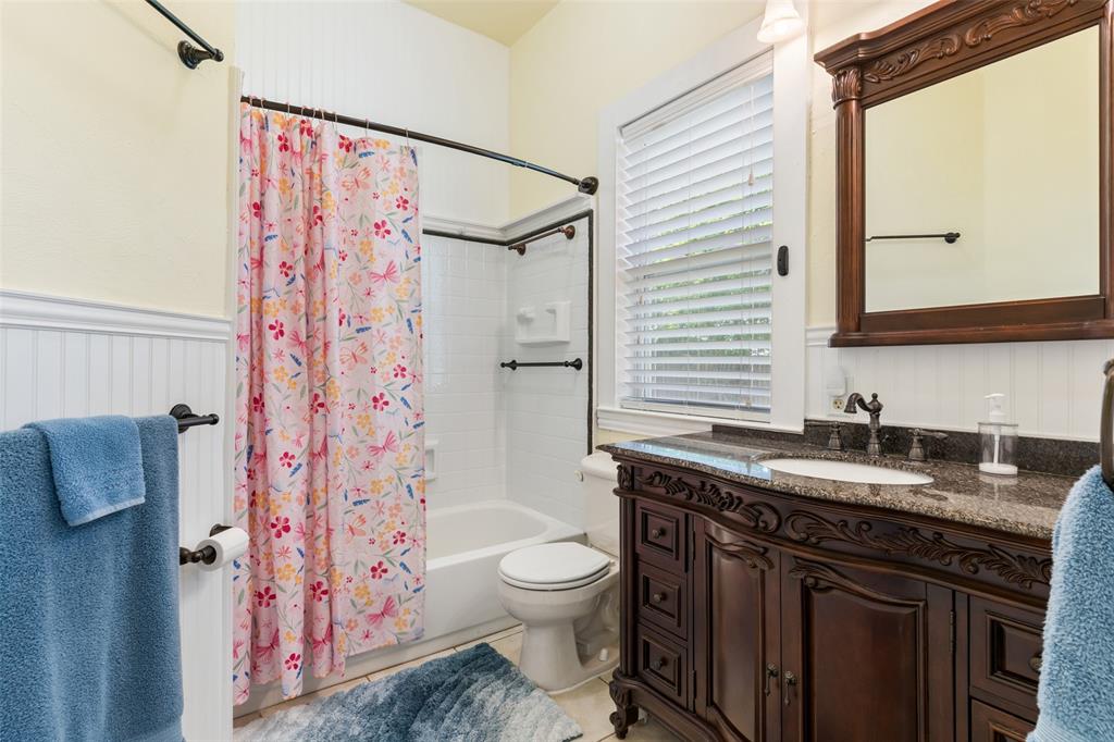 5824 Boone Street Sachse, TX 75048 - Photo 17 of 40 a bathroom with a granite countertop sink toilet and shower
