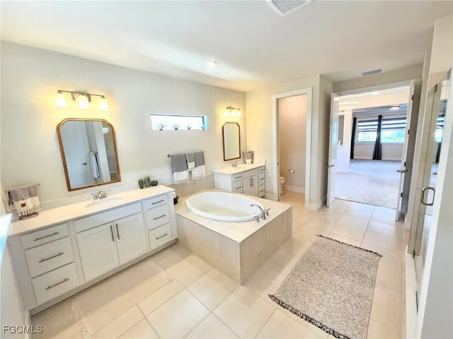 a bathroom with a sink double vanity and a mirror