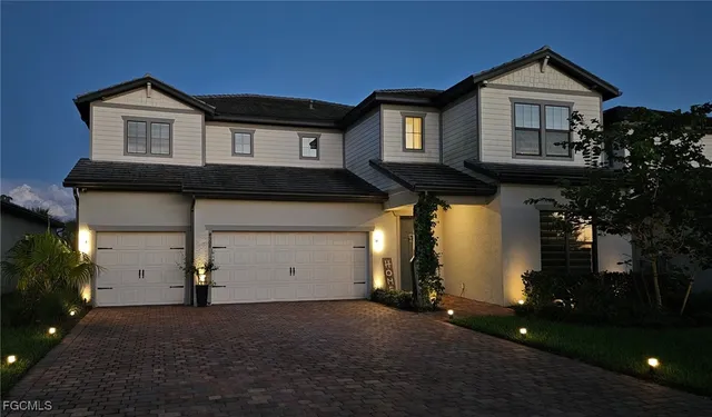 a front view of a house with a yard and garage