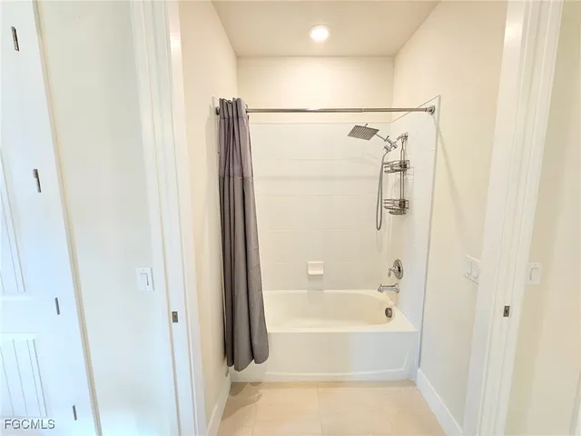 a spacious bathroom with a double vanity sink and a mirror