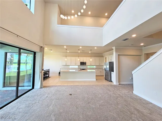 a view of a big room with windows and chandelier