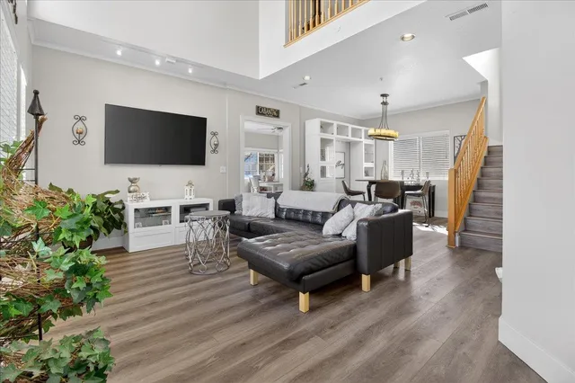a view of a dining room with furniture and wooden floor
