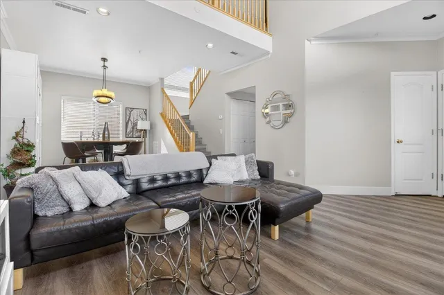 a dining room with furniture potted plants and wooden floor