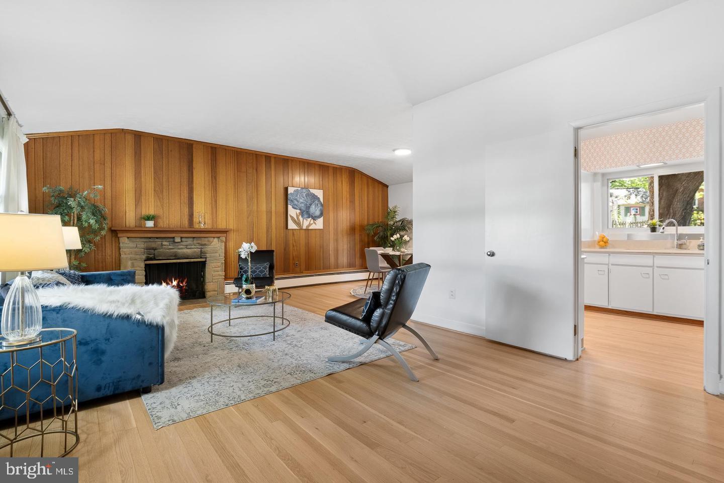 1006 Strout Street Silver Spring, MD 20901 - Photo 2 of 3 a living room with furniture a fireplace and a flat screen tv