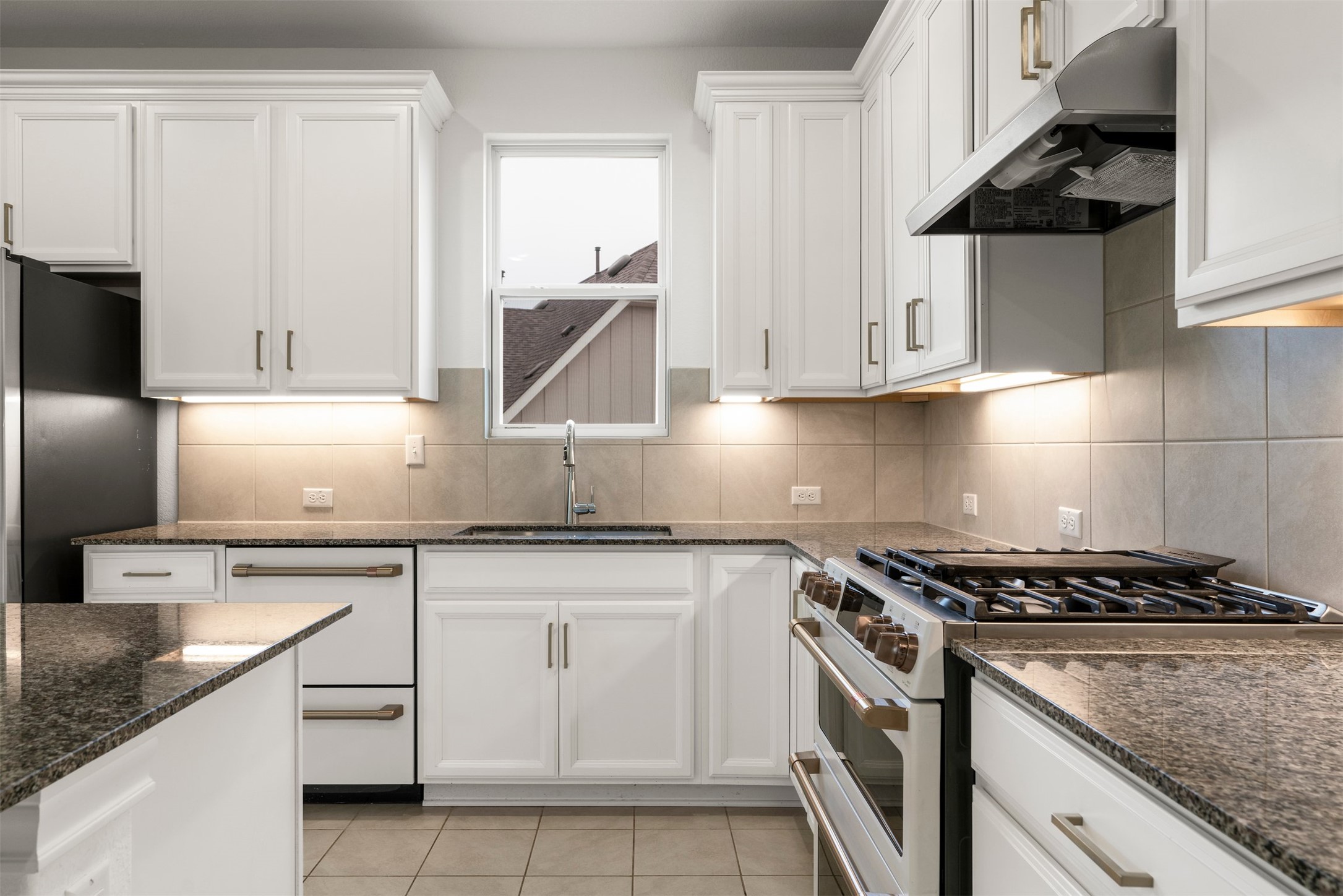 302 Barn Hill Loop Dripping Springs, TX 78620 - Photo 14 of 40 The kitchen layout prioritizes efficiency, with everything within easy reach and clear pathways that keep the space feeling open