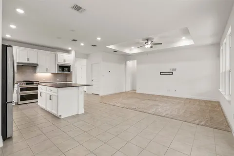 a bathroom with a sink double vanity granite tub shower and a mirror