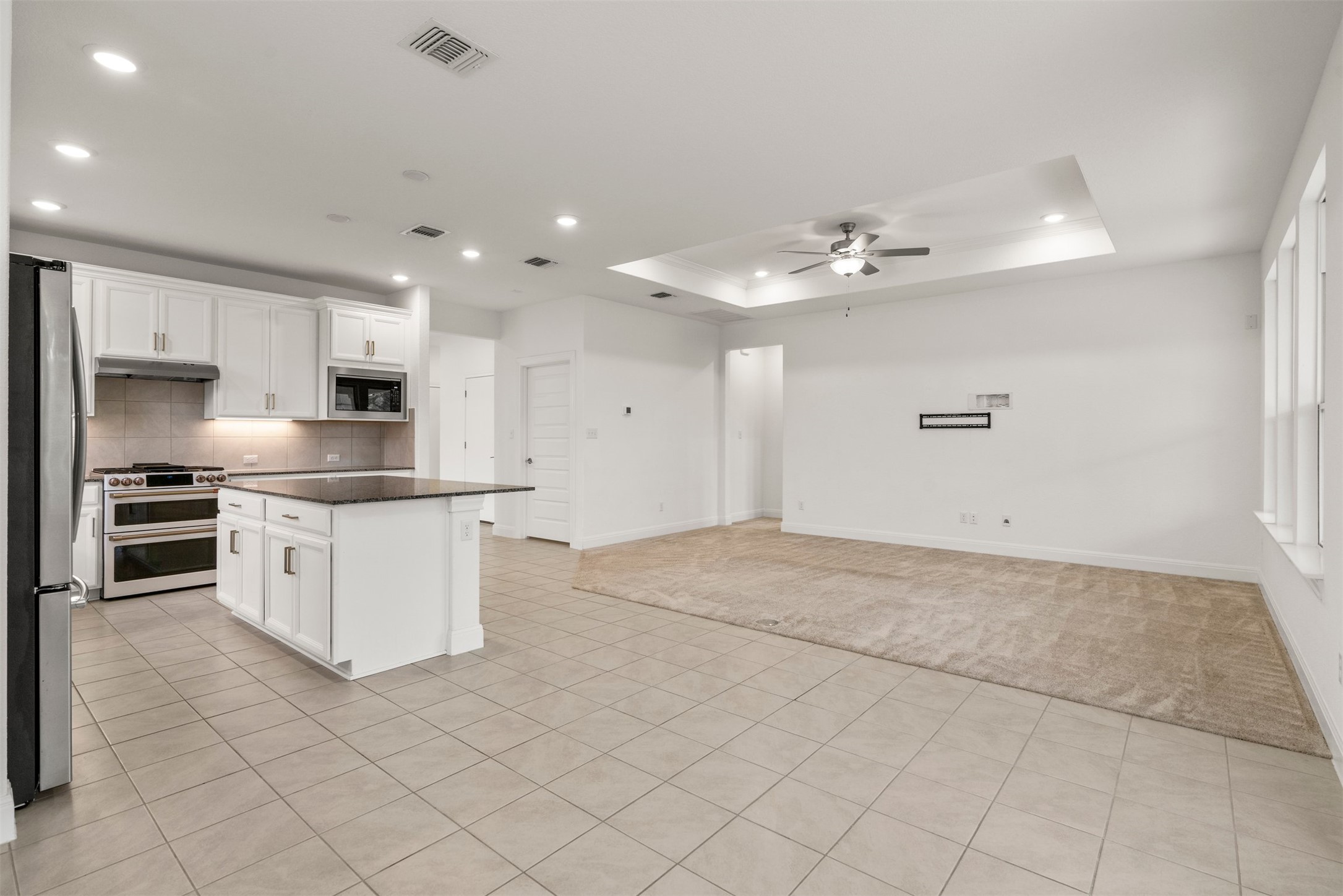 302 Barn Hill Loop Dripping Springs, TX 78620 - Photo 17 of 40 Positioned between the living room and backyard access, the kitchen works as a true hub for day-to-day living in Caliterra