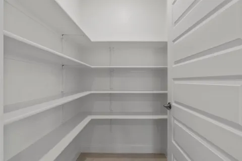 a spacious bathroom with a granite countertop sink a mirror and shower