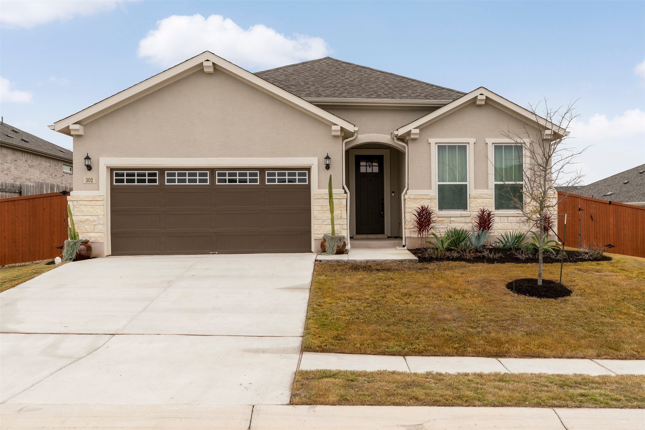302 Barn Hill Loop Dripping Springs, TX 78620 - Photo 2 of 40 The front of the home sits along a quieter stretch of Caliterra, framed by soft landscaping and a setting that feels relaxed from the moment you arrive