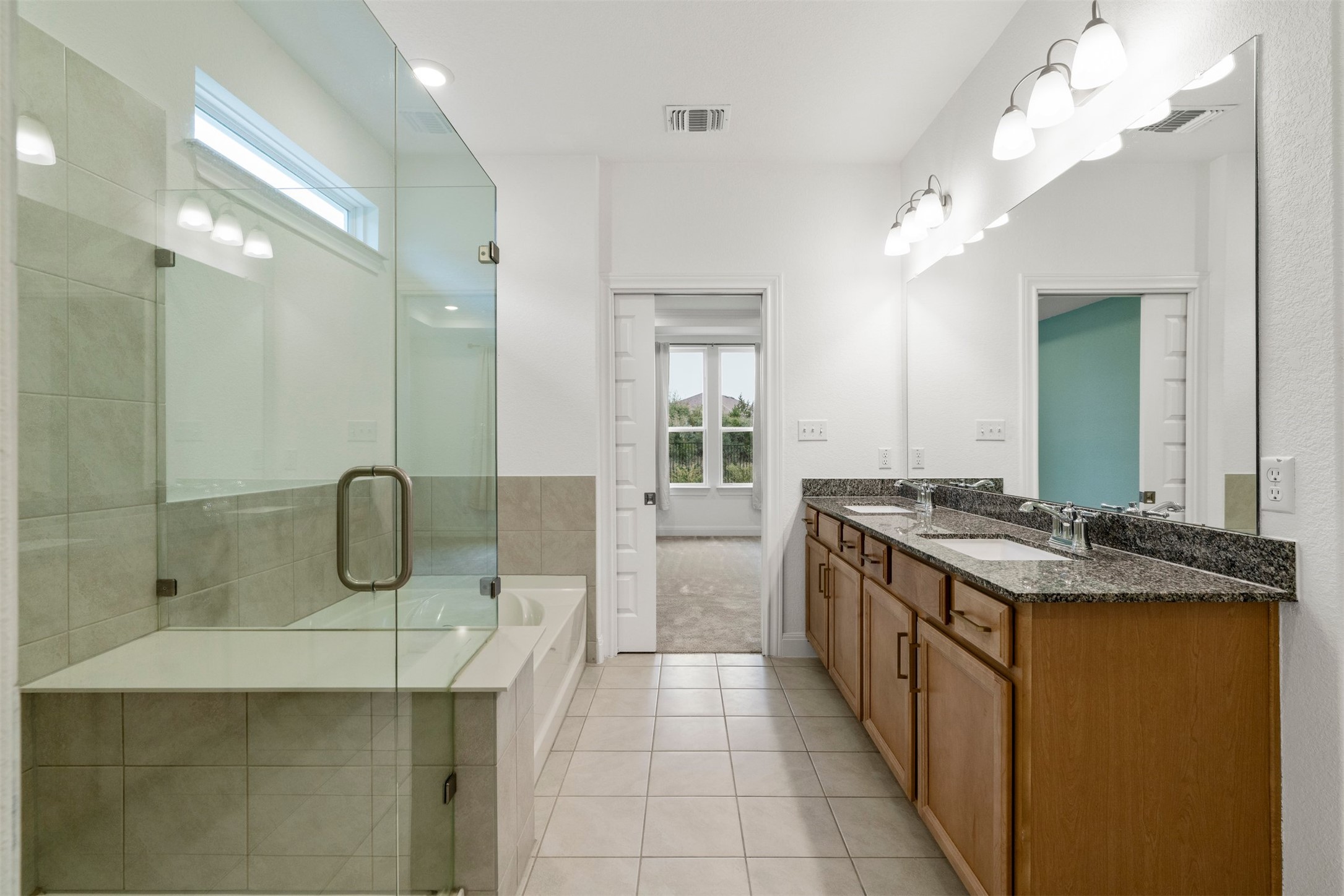 302 Barn Hill Loop Dripping Springs, TX 78620 - Photo 21 of 40 a spacious bathroom with a granite countertop sink a mirror and shower