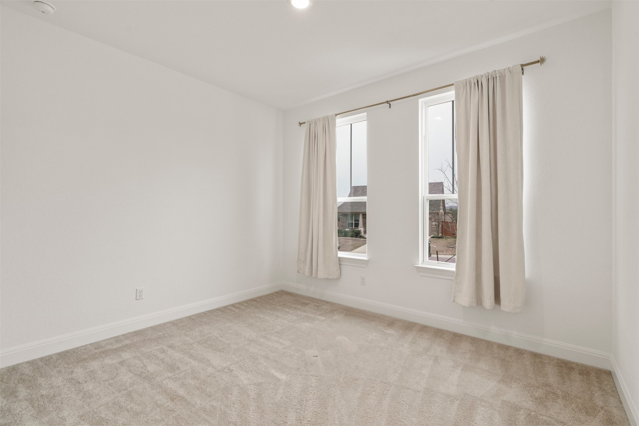 302 Barn Hill Loop Dripping Springs, TX 78620 - Photo 23 of 40 an empty room with windows