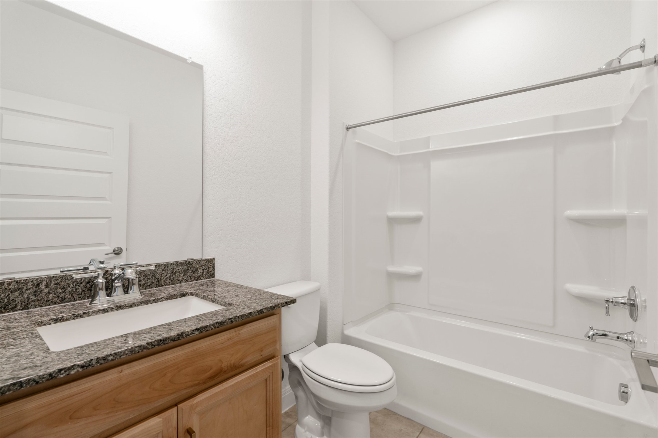 302 Barn Hill Loop Dripping Springs, TX 78620 - Photo 24 of 40 a bathroom with a granite countertop sink toilet and shower