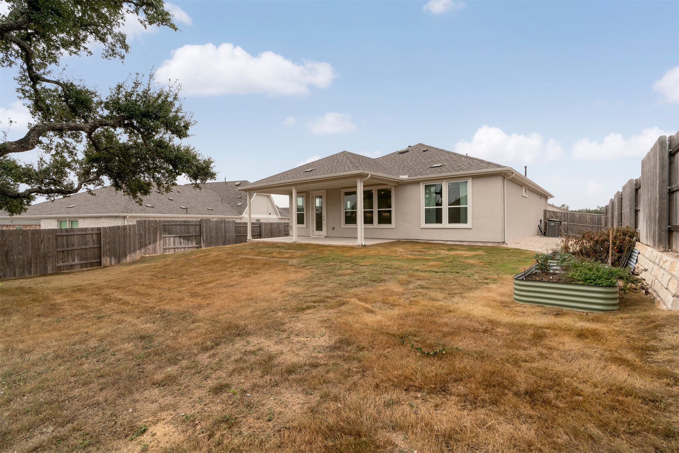 302 Barn Hill Loop Dripping Springs, TX 78620 - Photo 29 of 40 a front view of a house with a yard