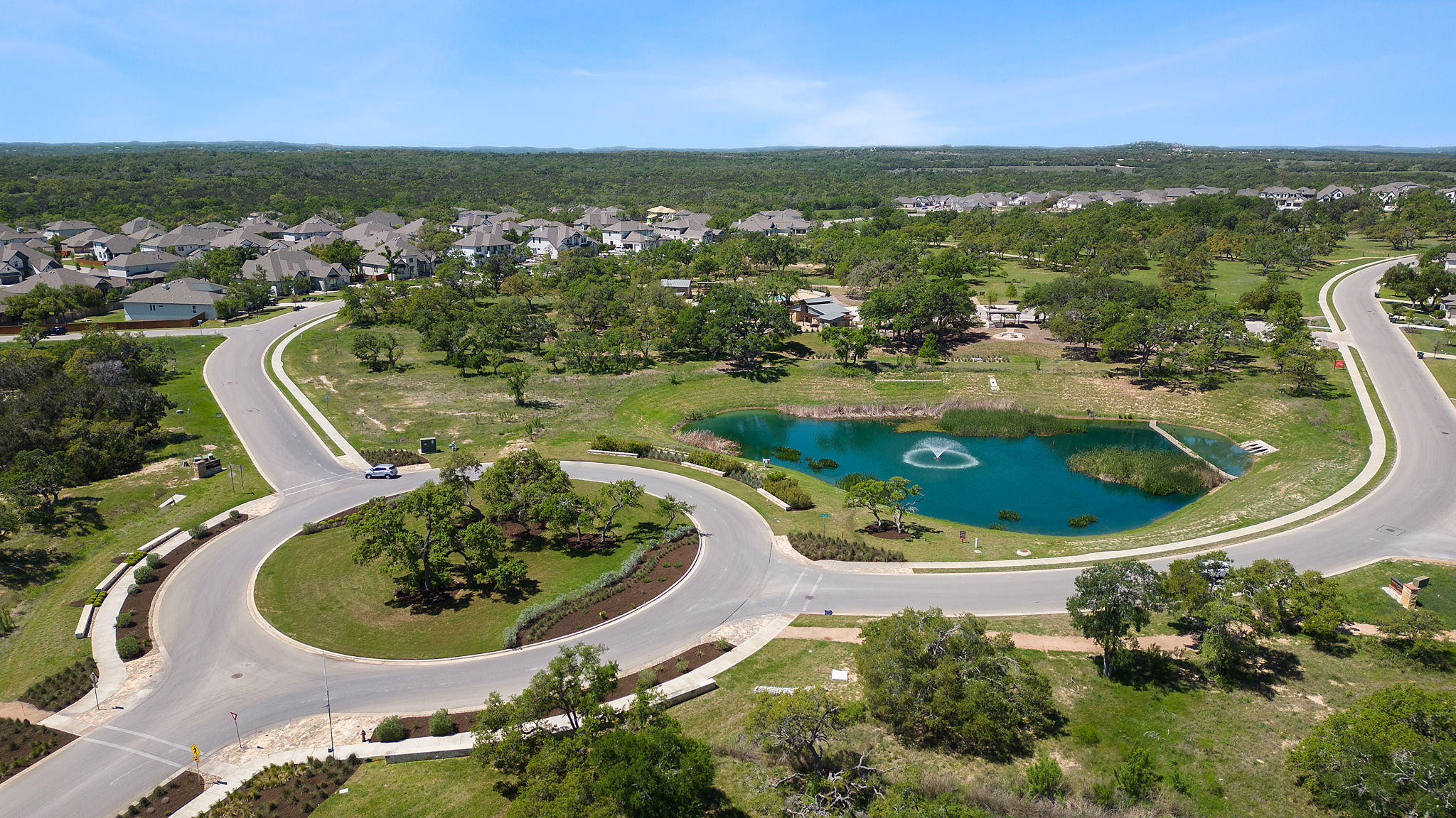 302 Barn Hill Loop Dripping Springs, TX 78620 - Photo 38 of 40 Carefully maintained landscaping and preserved natural areas give Caliterra a cohesive, Hill Country feel that carries throughout the entire neighborhood