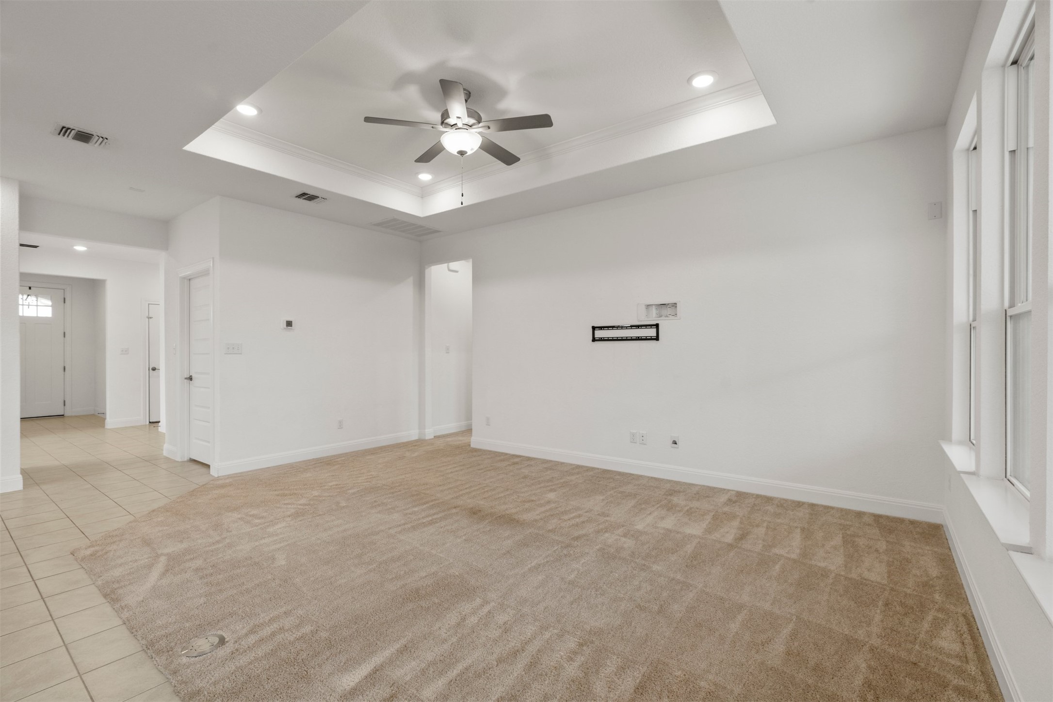 302 Barn Hill Loop Dripping Springs, TX 78620 - Photo 10 of 40 A tray ceiling adds subtle architectural interest overhead, giving the living room a sense of depth