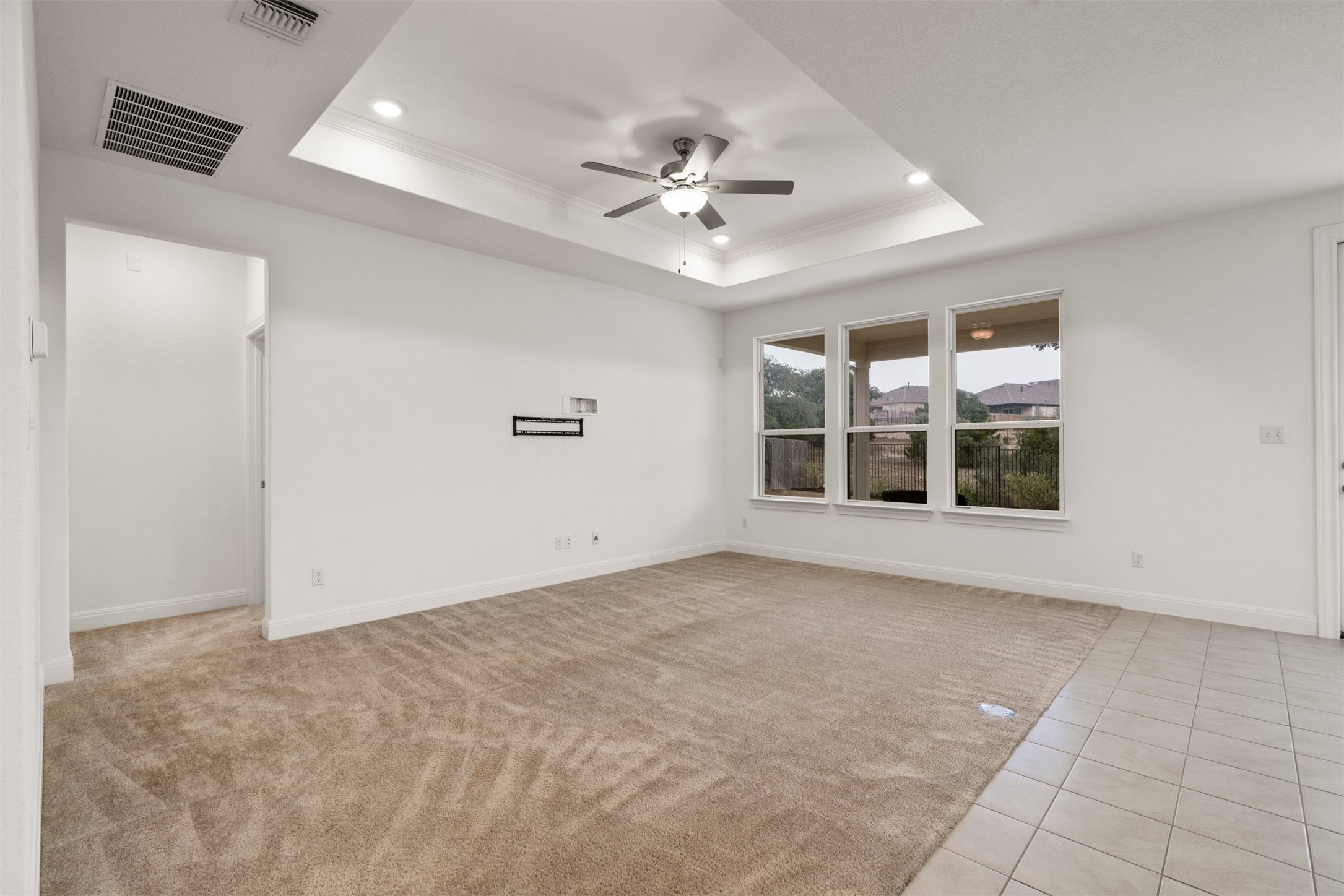 302 Barn Hill Loop Dripping Springs, TX 78620 - Photo 10 of 40 an empty room with windows and ceiling fan