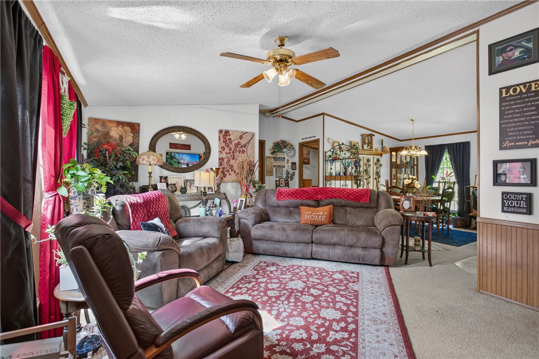 418 Chauga Road Westminster, SC 29693 - Photo 2 of 38 A well-lit gathering space with inviting sofas and a warm color palette offers comfortable living.