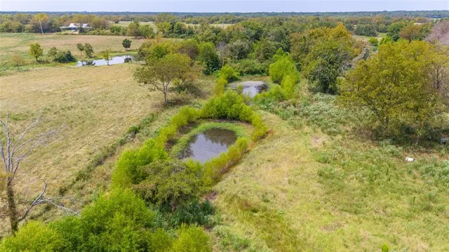 a view of a house with pool and a yard