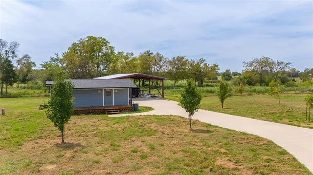 a view of swimming pool with a garden and trees