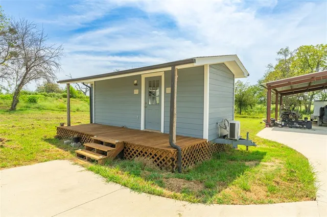 a view of swimming pool with lawn chairs and plants