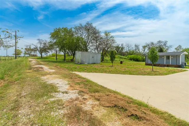 a view of a big yard with table and chairs
