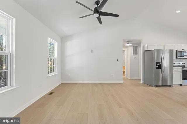 wooden floor in an empty room with a window