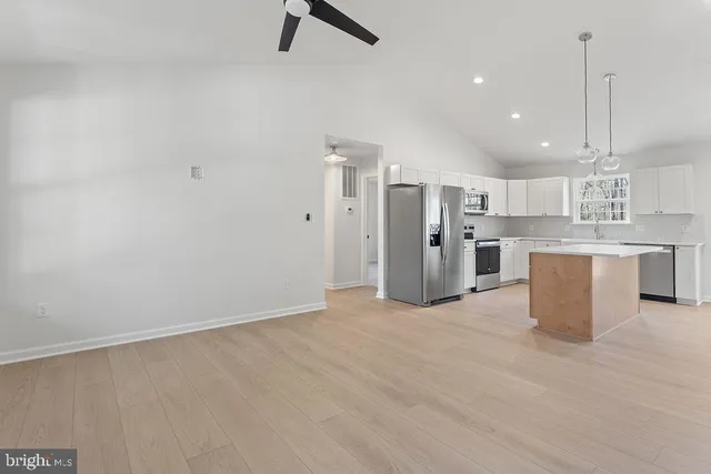 a spacious bedroom with a bed and a window
